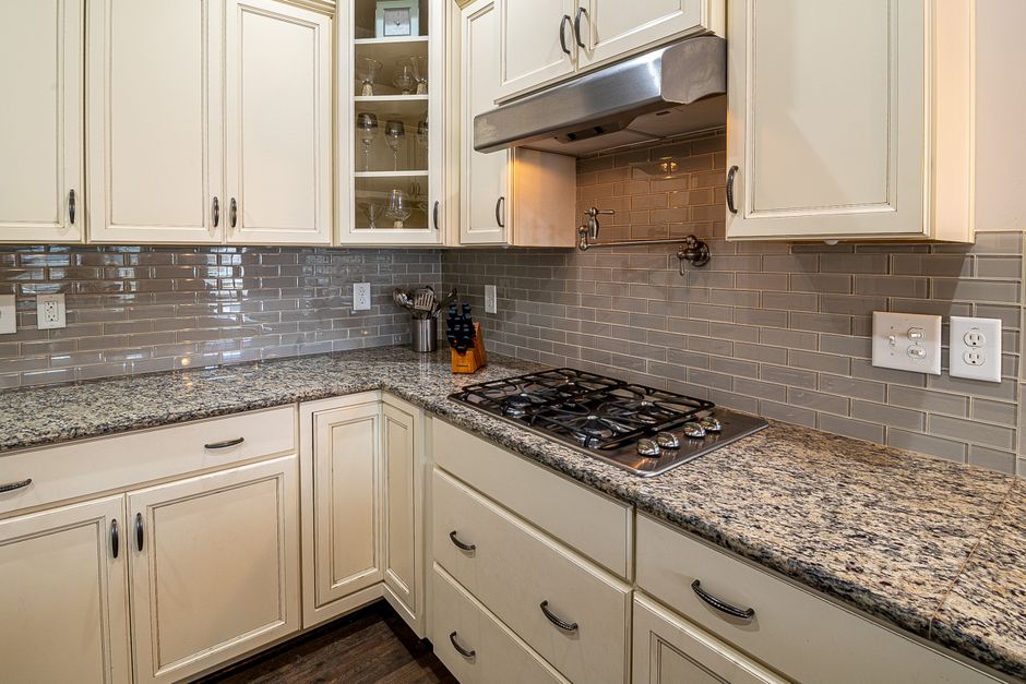 Stylish kitchen featuring granite countertops, stainless steel stove, and modern cabinetry for a sleek design.